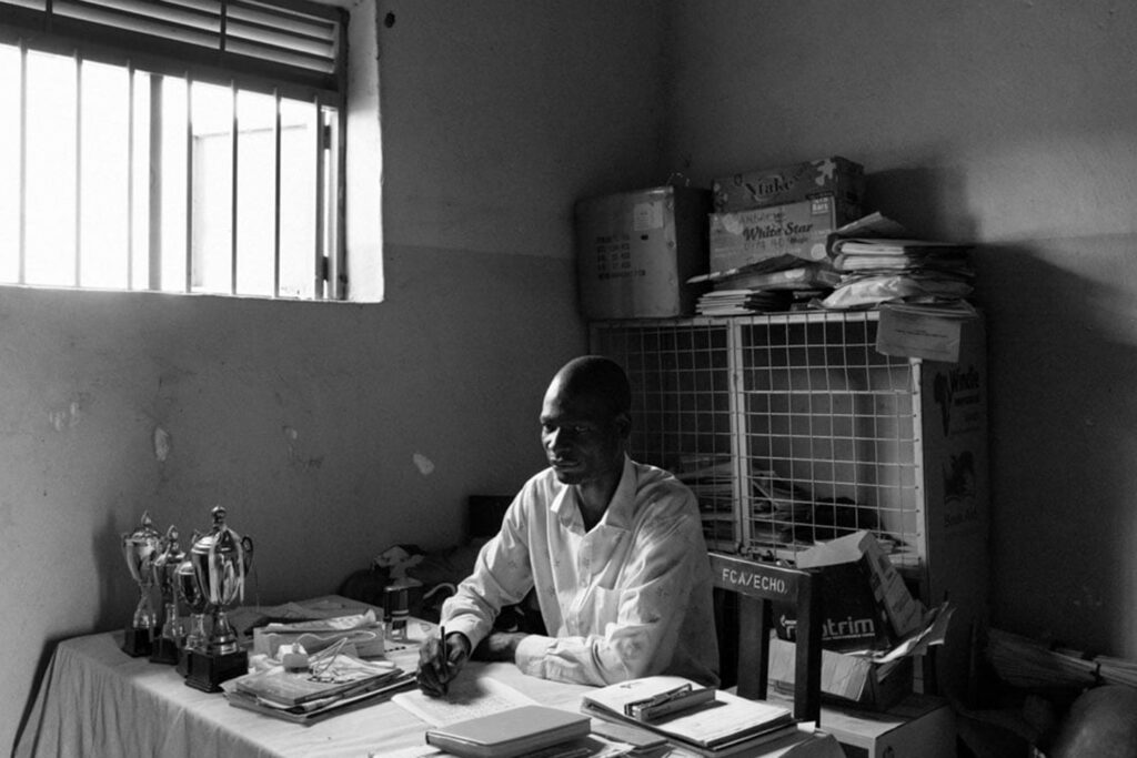 Teacher Walter Odong, 36, continues working at a school in Palabek, though his contract and those of his colleagues depend on renewed funding. Since early 2025, 200 students have left because they can no longer pay fees once subsidized by aid. "Without education, the youth will go back and join the military or other armed groups," he says. "We are killing their talent."